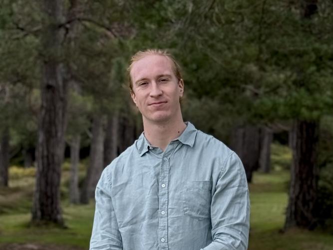 Guillaume stading in a forest